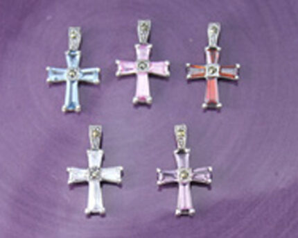 Five colorful cross pendants on purple background