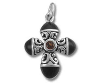Ornate silver cross pendant with brown gemstone