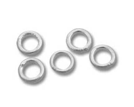 Five silver jump rings on white background
