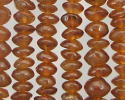 Rows of polished amber beads on strings