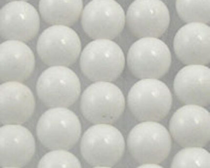 Repeating pattern of white glossy spheres