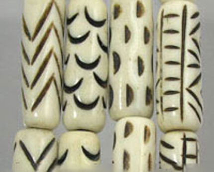 Carved bone beads with geometric black patterns