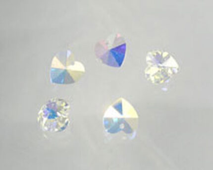 Iridescent heart-shaped crystals on white background