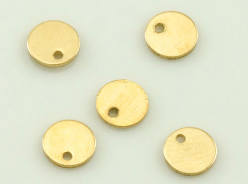 Five small brass discs with edge holes