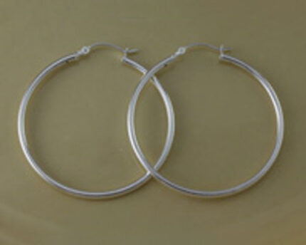 Pair of silver hoop earrings on tan background
