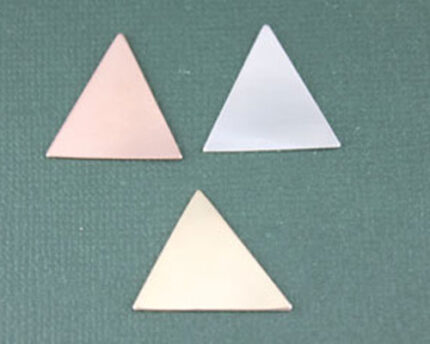 Three pastel triangular tiles on textured green surface