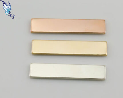 Three metallic rectangular bars in different finishes