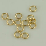 Gold jump rings on light background