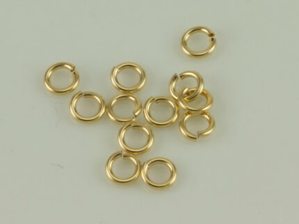 Gold jump rings on light background