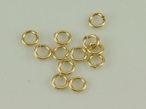 Gold jump rings on light background Gold jump rings on light background