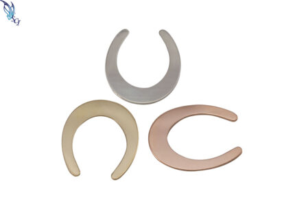 Three crescent-shaped metal jewelry pieces