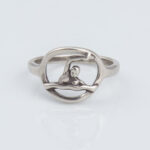 Silver ring with human figure inside circular frame
