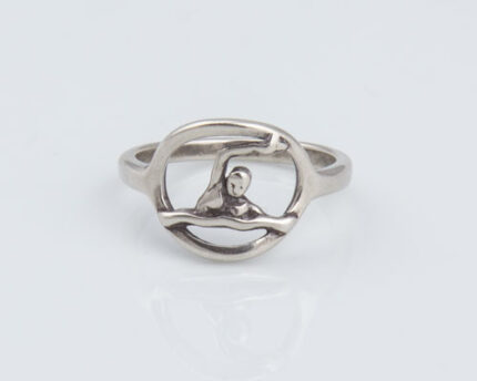 Silver ring with human figure inside circular frame