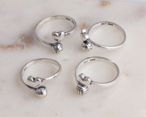 Silver rings with heart and sports ball charms