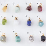 Twelve raw gemstone pendants with gold caps