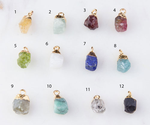Twelve raw gemstone pendants with gold caps
