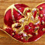 Red enamel hat brooch with gold trim