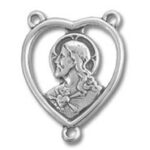 Silver heart-shaped pendant with woman's profile
