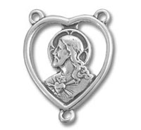 Silver heart-shaped pendant with woman's profile