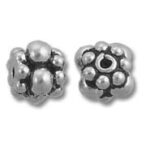 Two ornate silver flower-shaped beads