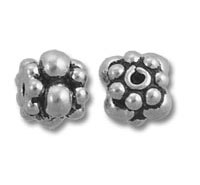 Two ornate silver flower-shaped beads