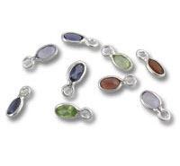 Assorted oval gemstone charms with silver settings