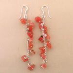 Dangling coral chip earrings with silver hooks