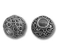 Two ornate silver round bead charms