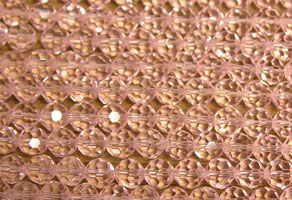 Close-up of pink beaded fabric