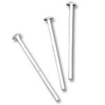 Three silver steel nails on white background