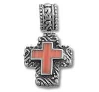 Ornate silver cross pendant with red inlay