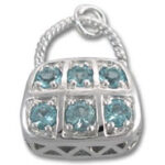 Silver purse charm with six blue gemstones