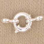 Silver toggle clasp on beige fabric
