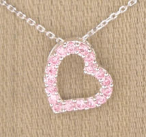 Pink gemstone open-heart pendant on silver chain