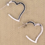 White heart-shaped hoop earrings with black trim