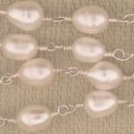 Linked freshwater pearl necklace on beige fabric