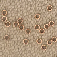 Copper eyelets on textured beige fabric