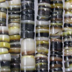 Close-up of striped shell beads on strands