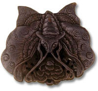 Intricate carved wooden moth ornament