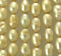 Close-up of lustrous golden pearl beads