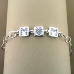 Silver bracelet with three square crystal charms