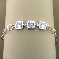 Silver bracelet with three square crystal charms