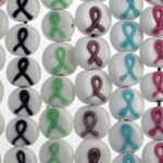 Array of awareness ribbon pins in various colors