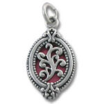 Ornate silver oval pendant with red enamel