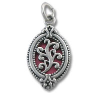 Ornate silver oval pendant with red enamel