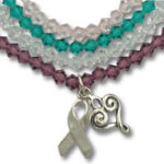 Multistrand beaded bracelet with ribbon and heart charms