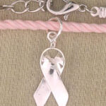 Silver breast cancer ribbon charm on pink bracelet