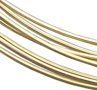 Gold metal bangles on white background