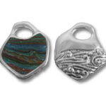 Two silver pendants, one with stone inlay