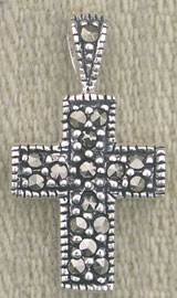 Silver marcasite cross pendant on fabric